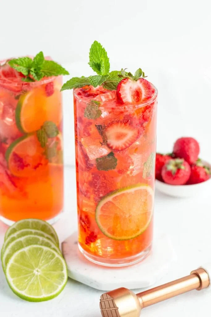 Refreshing easy strawberry mojito mocktail served in a glass with mint leaves.