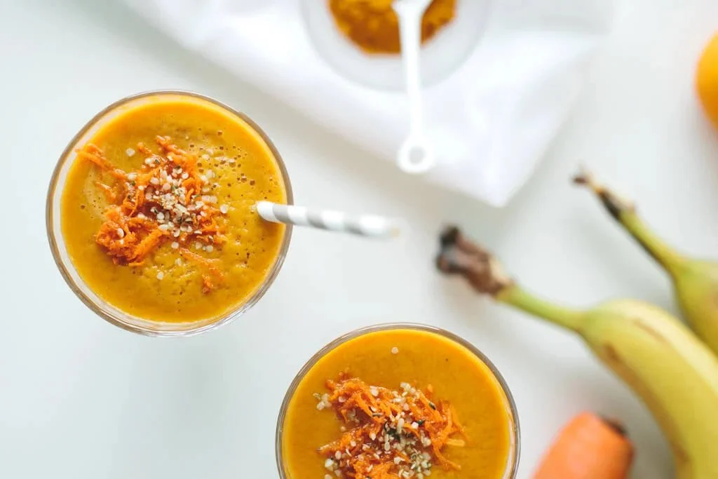 Golden Beet, Carrot and Turmeric Smoothie in a glass with vibrant colors