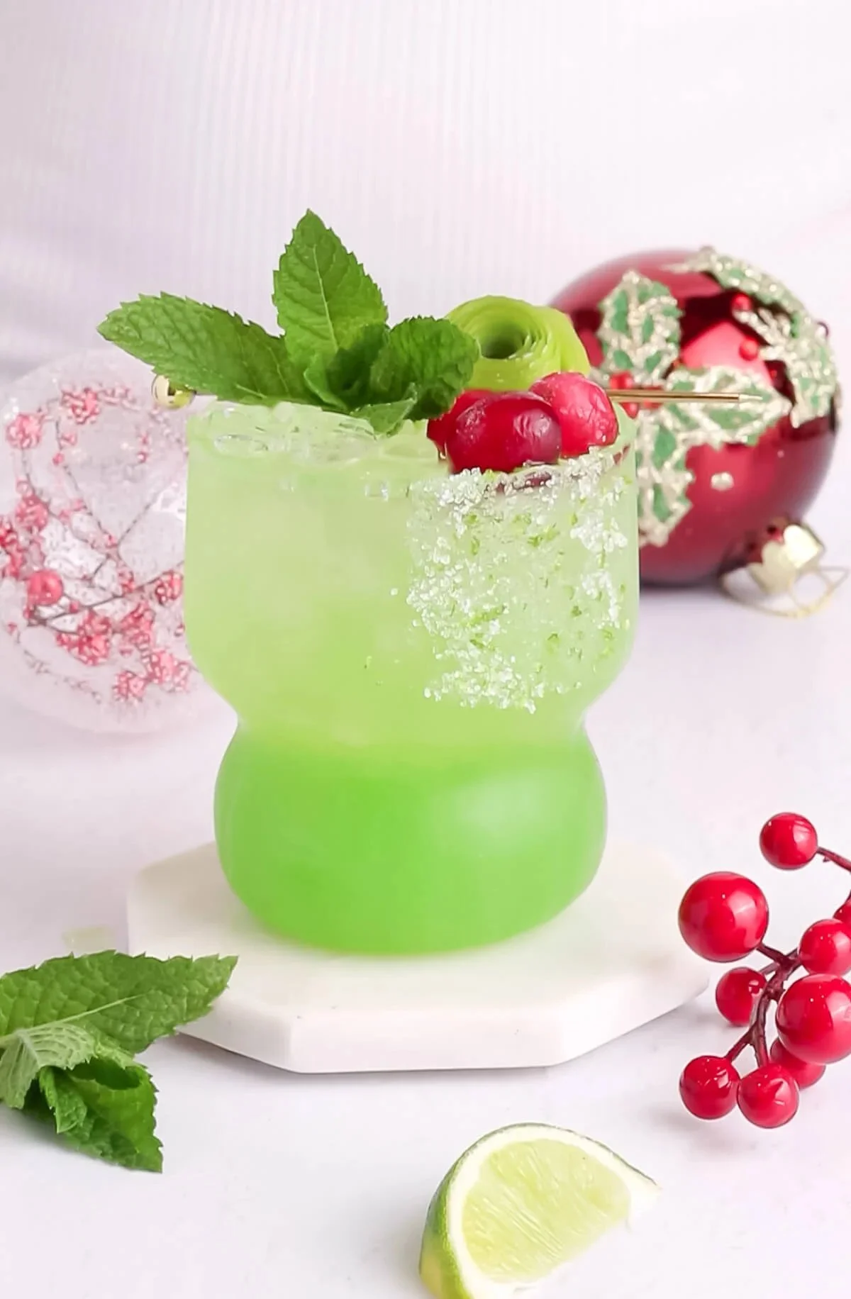 Festive Grinch Mocktail served in a holiday-themed glass