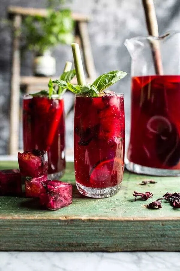 Hibiscus Lemongrass Basil Honey Sweet Iced Tea in a glass with fresh ingredients