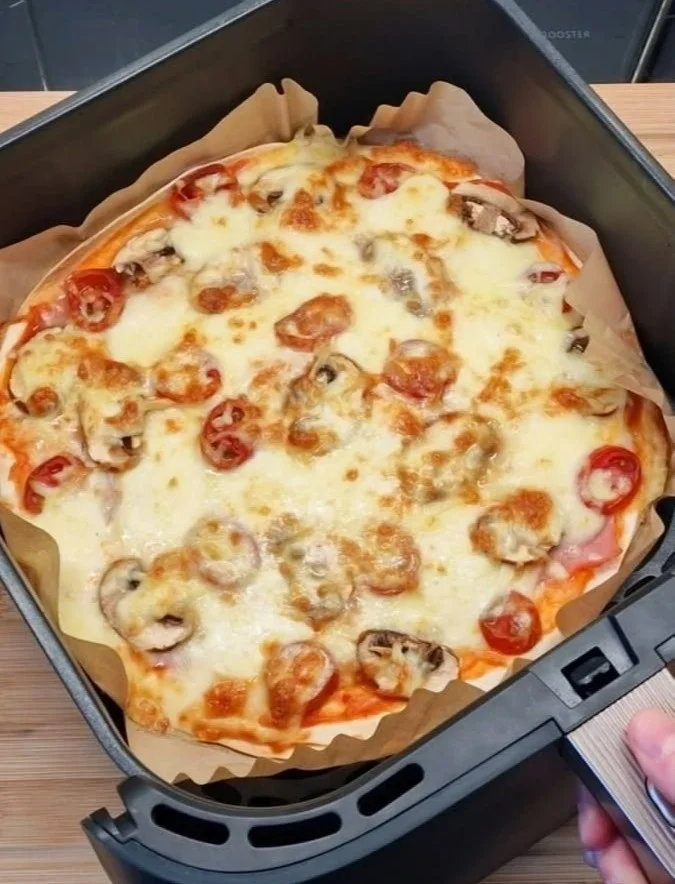 Delicious homemade air fryer pizza with fresh toppings and golden crust