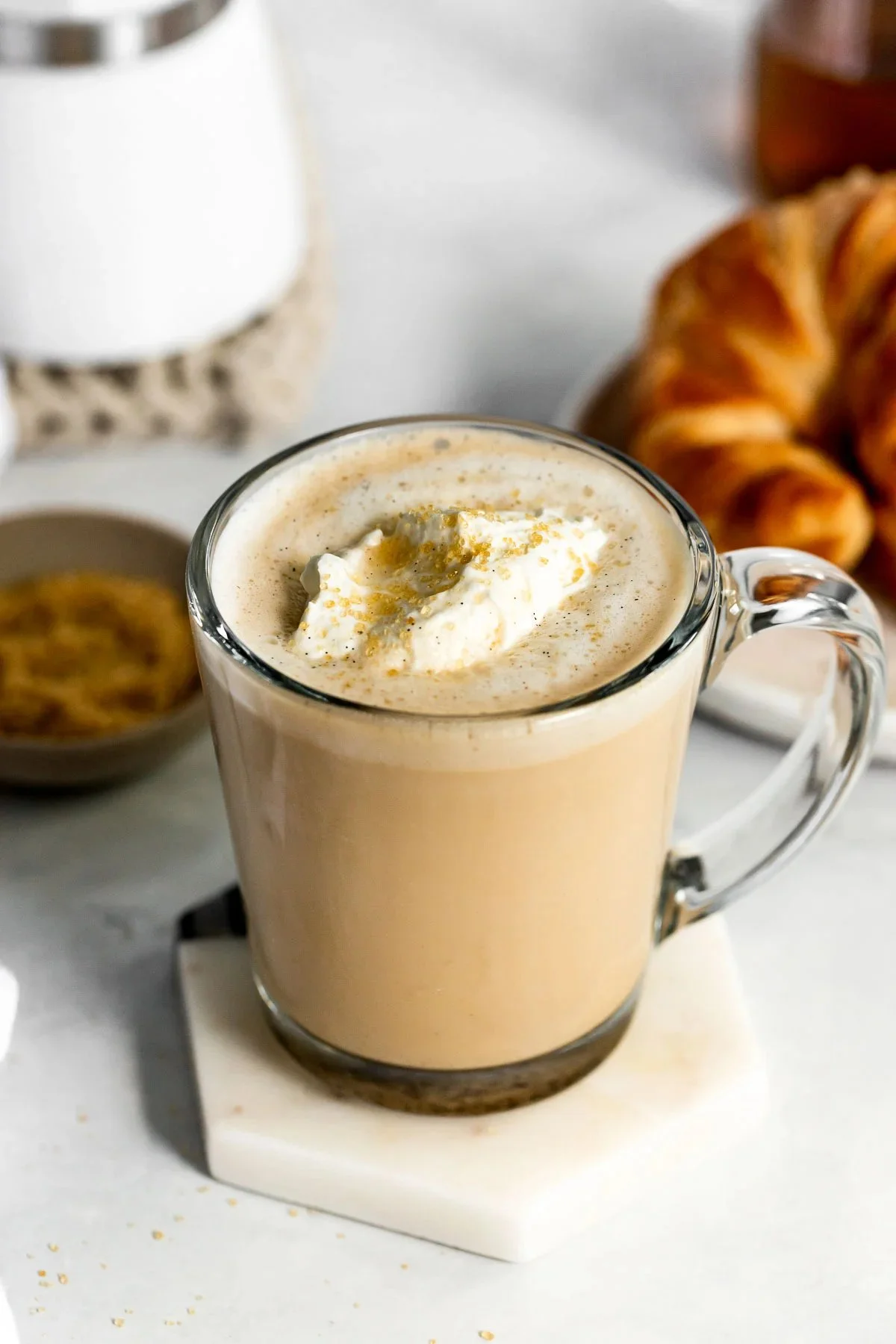 A homemade vanilla latte in a cup with frothy milk on top.