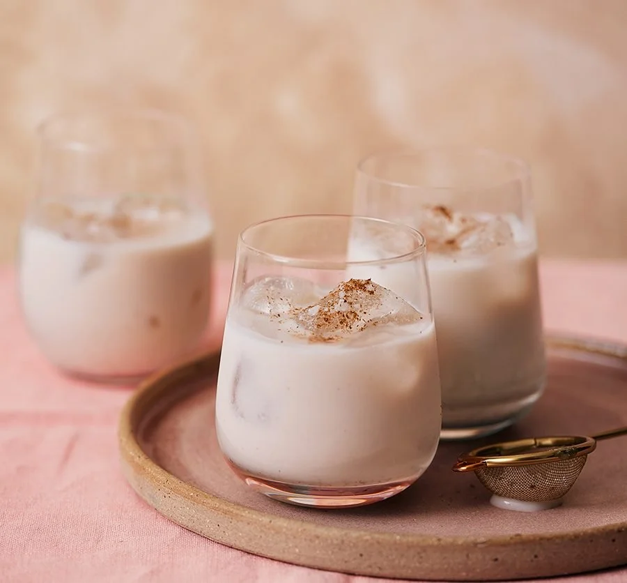 A glass of horchata, a traditional rice-based beverage garnished with cinnamon.