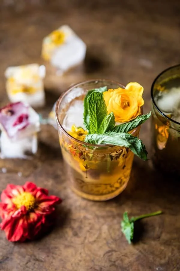 A refreshing glass of Iced Moroccan Mint Tea with fresh mint leaves and ice.