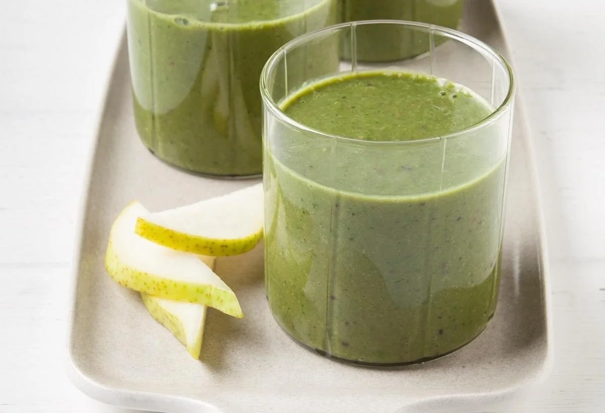 Healthy and refreshing kale smoothie in a glass with fruits