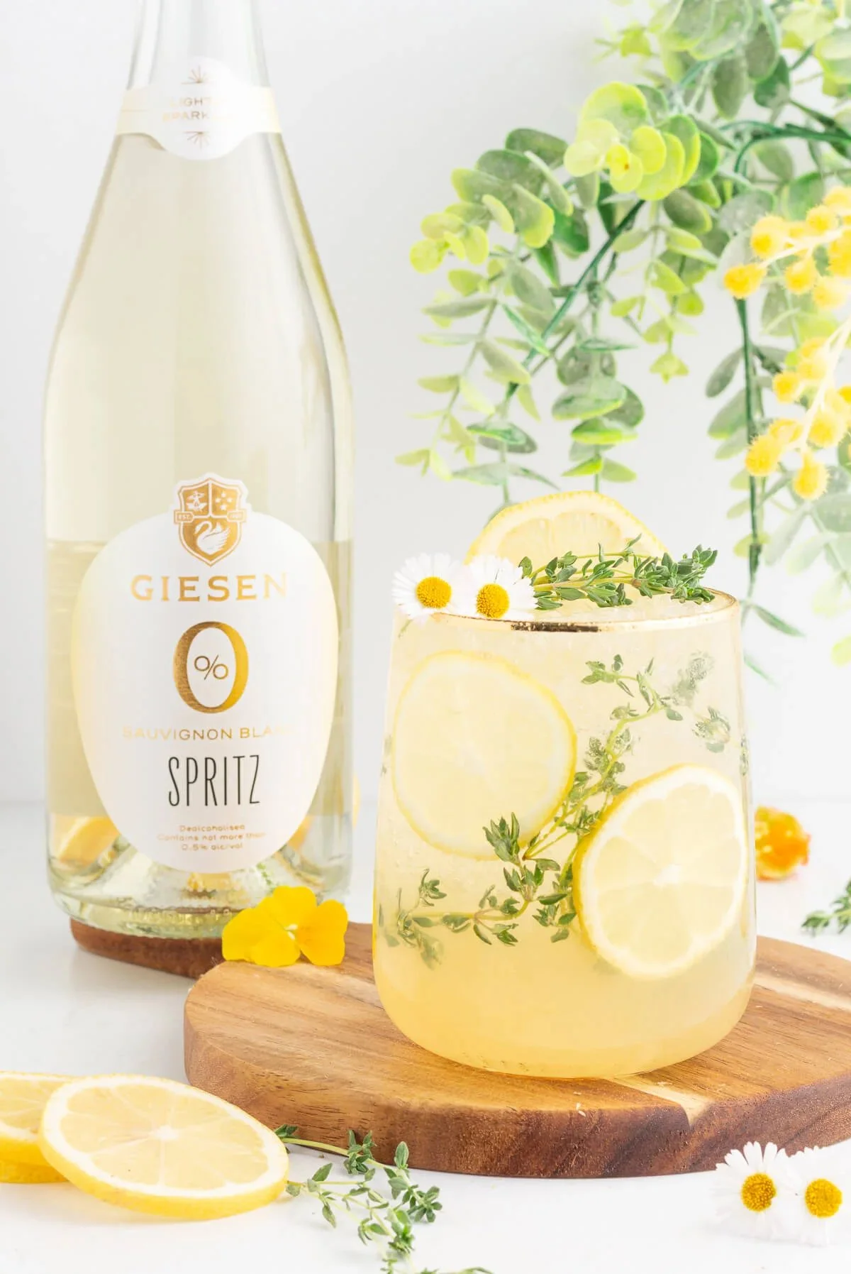 Lemon Chamomile Spritz mocktail in a glass garnished with lemon slices.