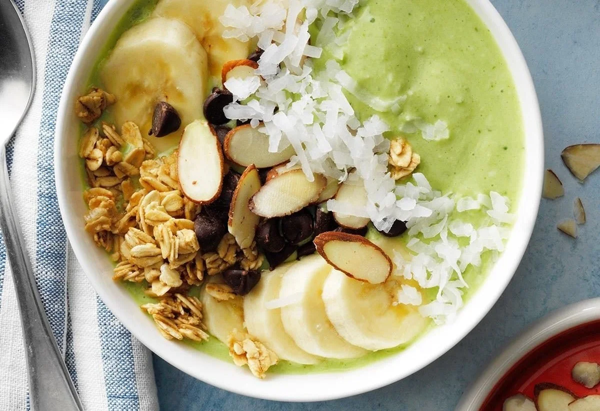 Delicious Lime Coconut Smoothie Bowl topped with fresh fruit and coconut flakes