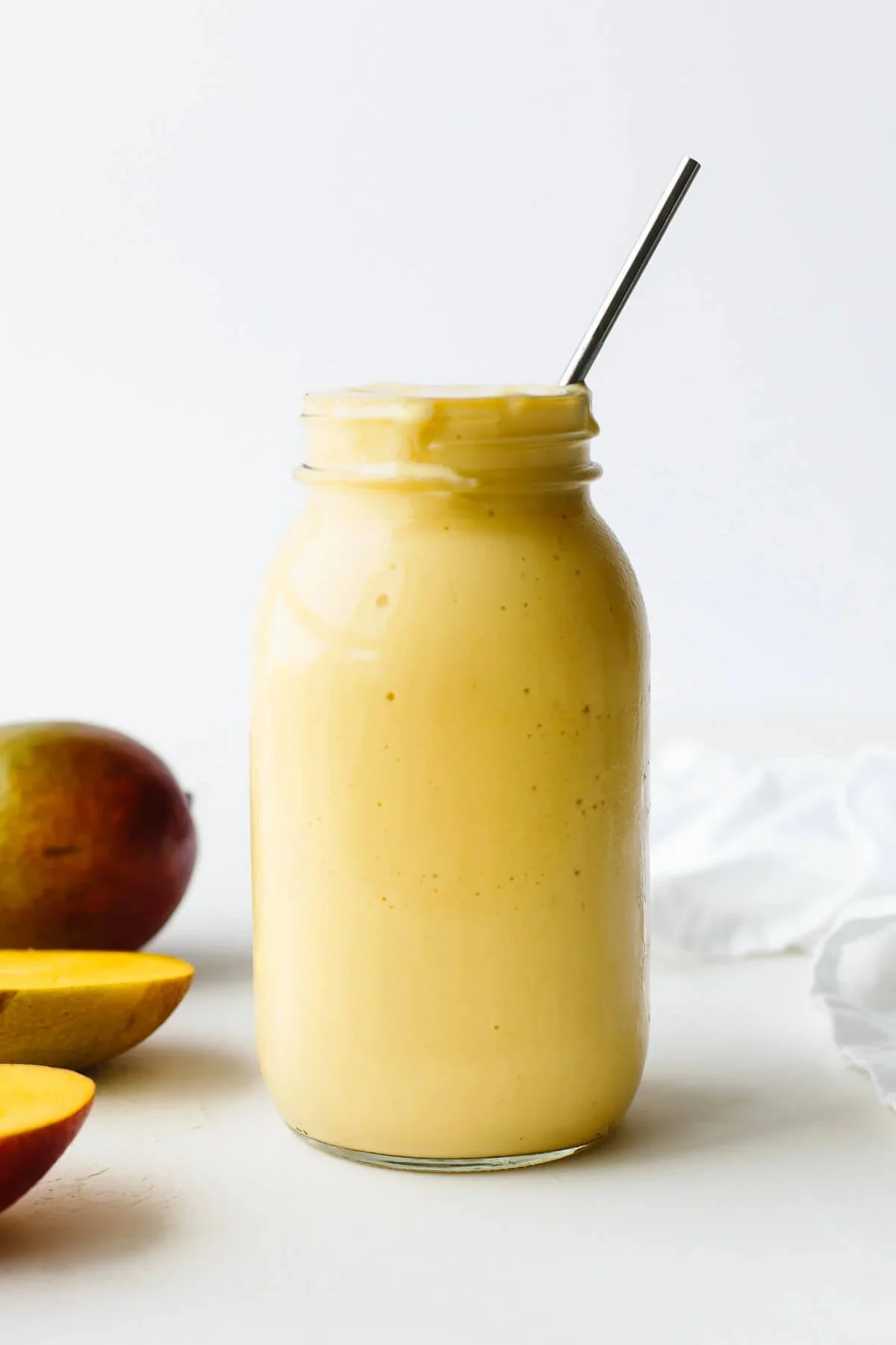 Refreshing mango smoothie topped with fresh fruit