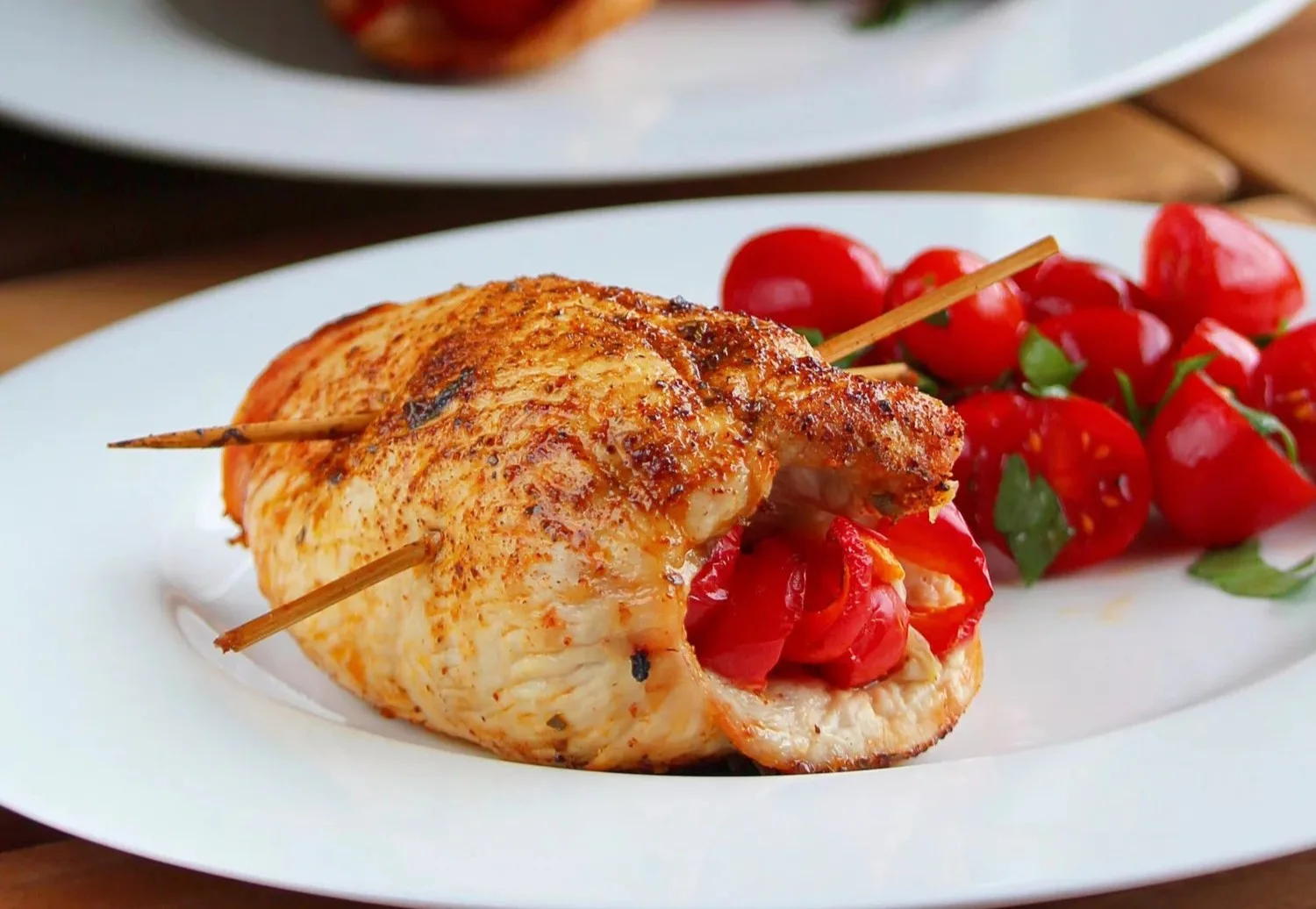 Mexican-style air fryer stuffed chicken breasts garnished with fresh herbs