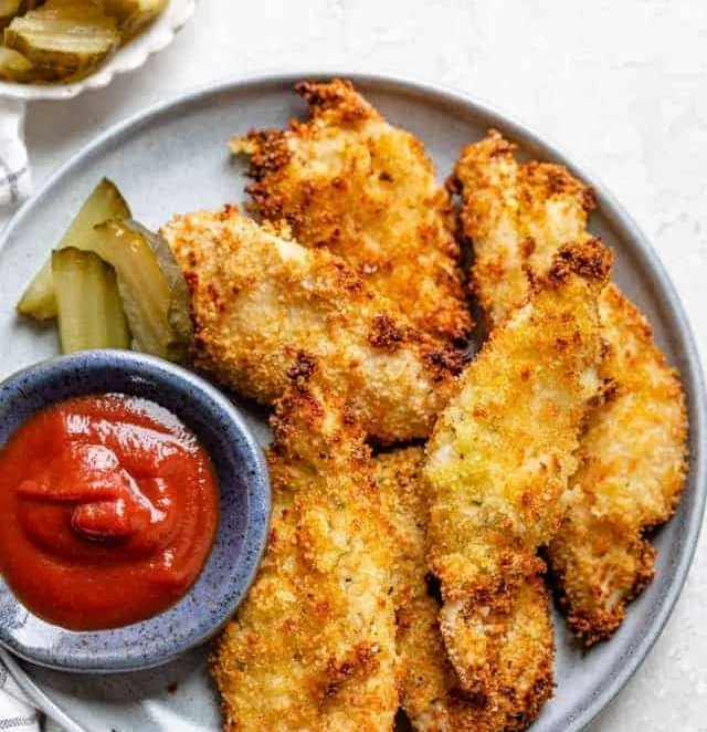Deliciously crispy pickle brined chicken tenders served with dipping sauce.