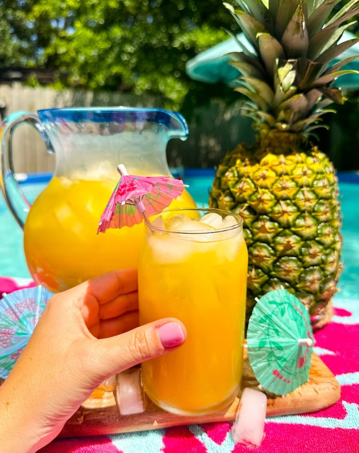 Pina Colada Punch served in a tropical-themed glass with fruit garnishes
