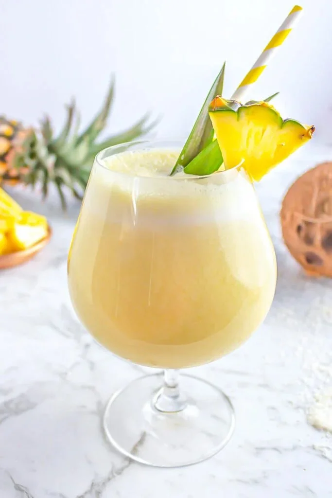 Refreshing Pineapple Coconut Mocktail served in a glass with garnishes.