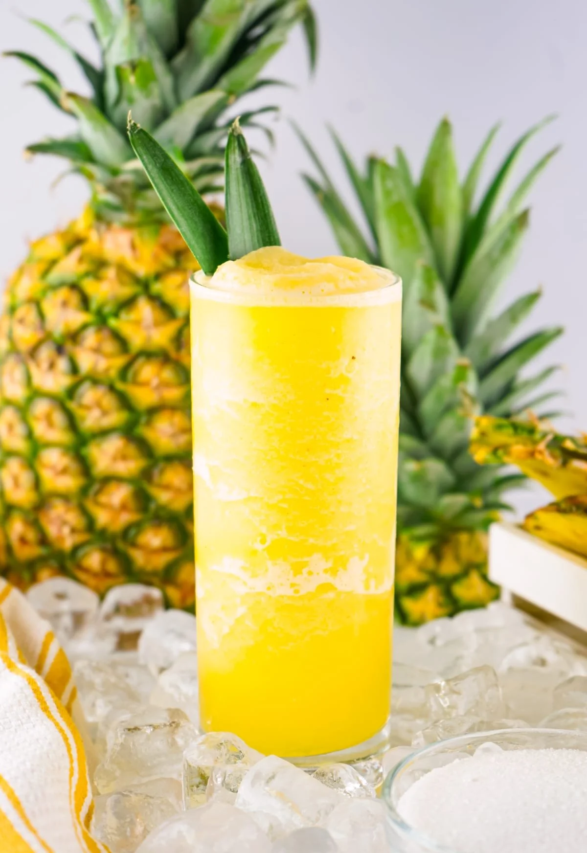 Delicious pineapple smoothie in a glass with fresh pineapple slices