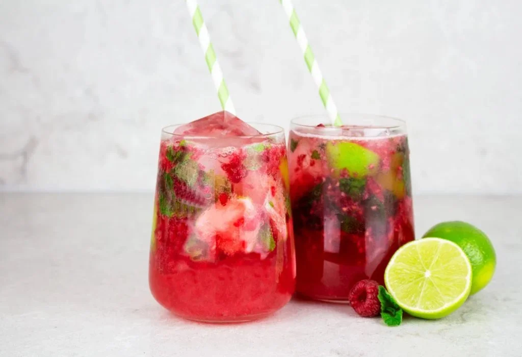 Refreshing Raspberry Mocktail in a glass with mint leaves and fresh raspberries