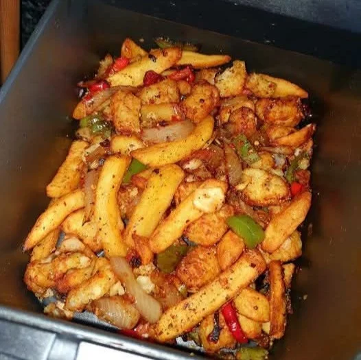 Delicious Salt and Pepper Chips with fresh peppers and onions served in a bowl.
