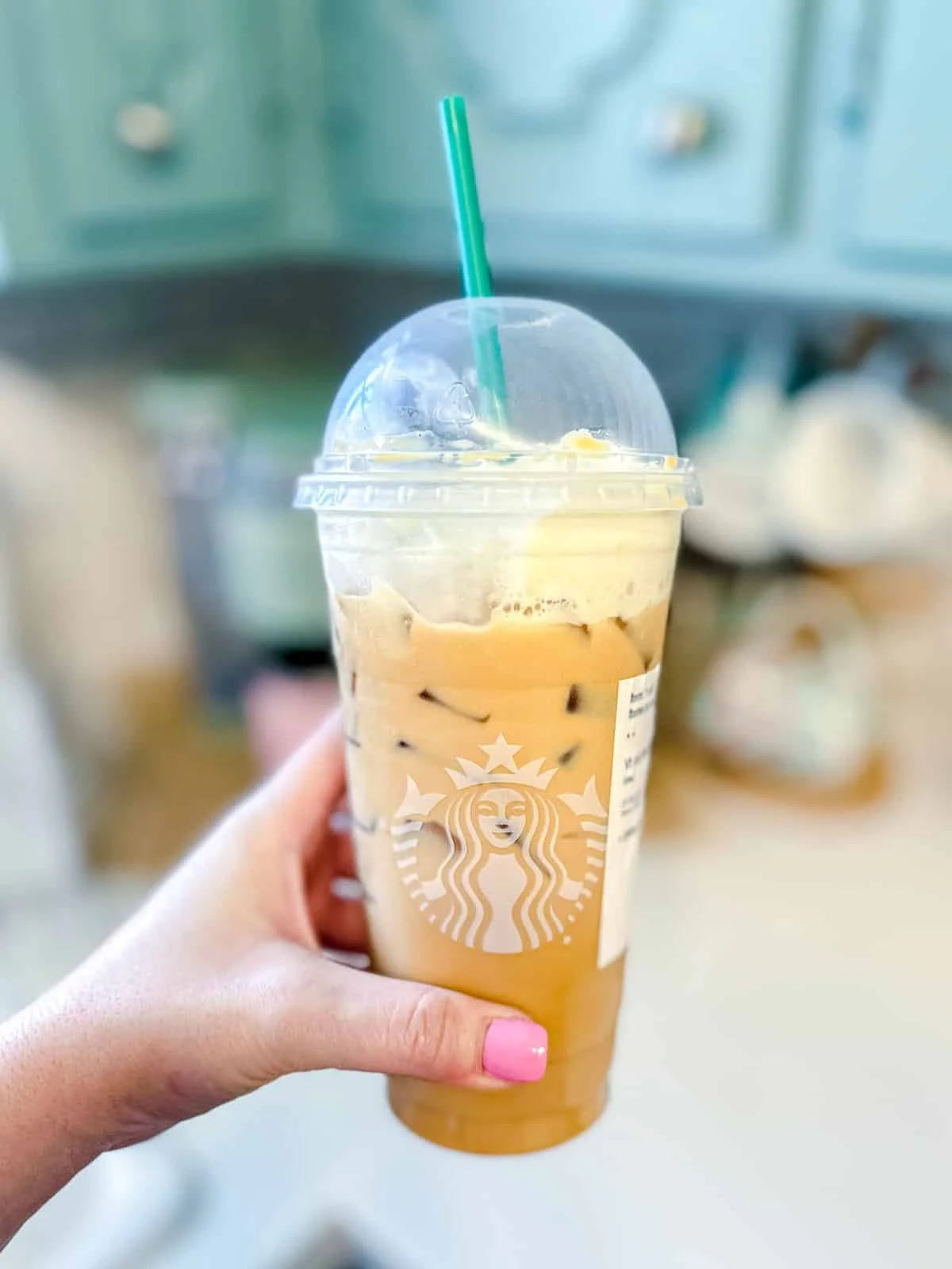 Starbucks Iced White Mocha with whipped cream and chocolate drizzle