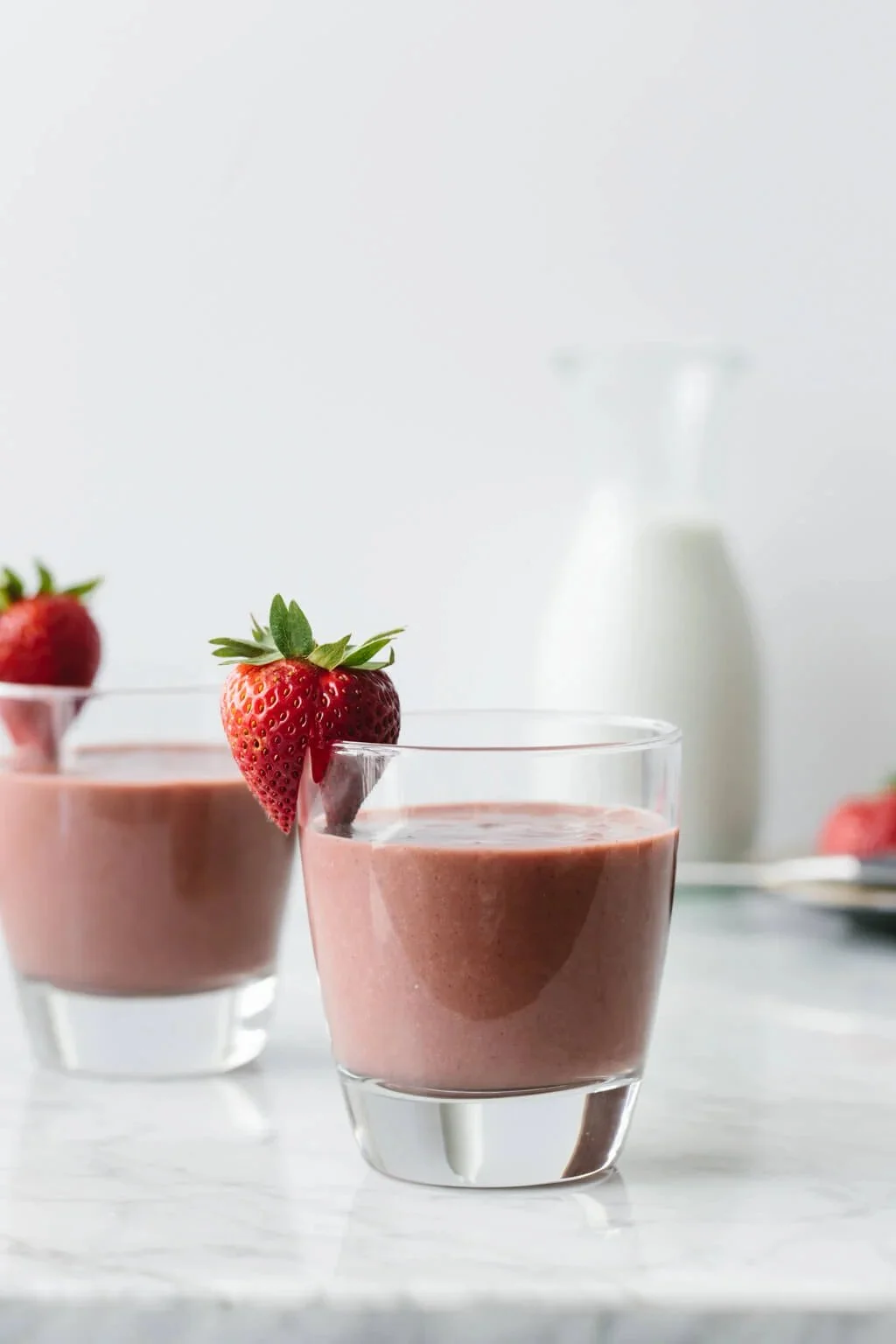 Delicious Strawberry Acai Smoothie in a glass with fresh strawberries