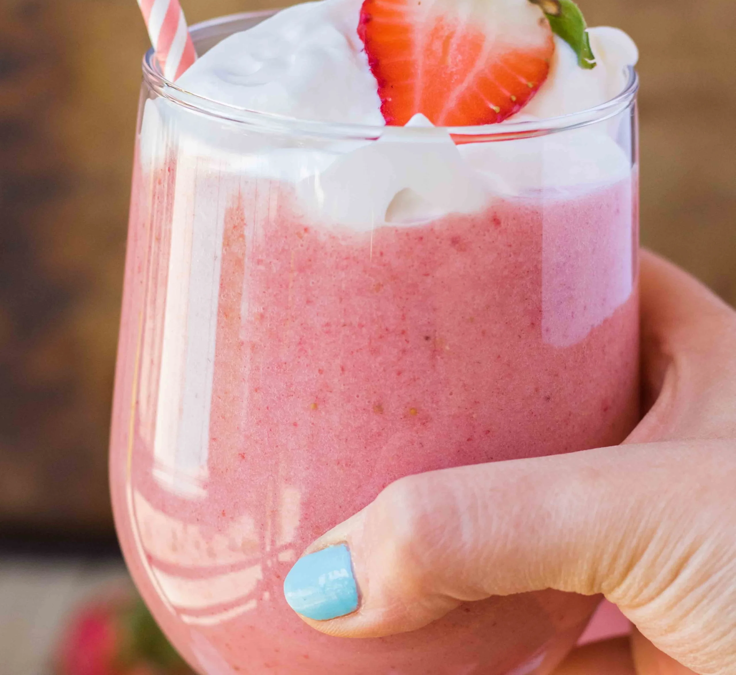 Delicious strawberry banana yogurt smoothie in a glass with fresh fruits