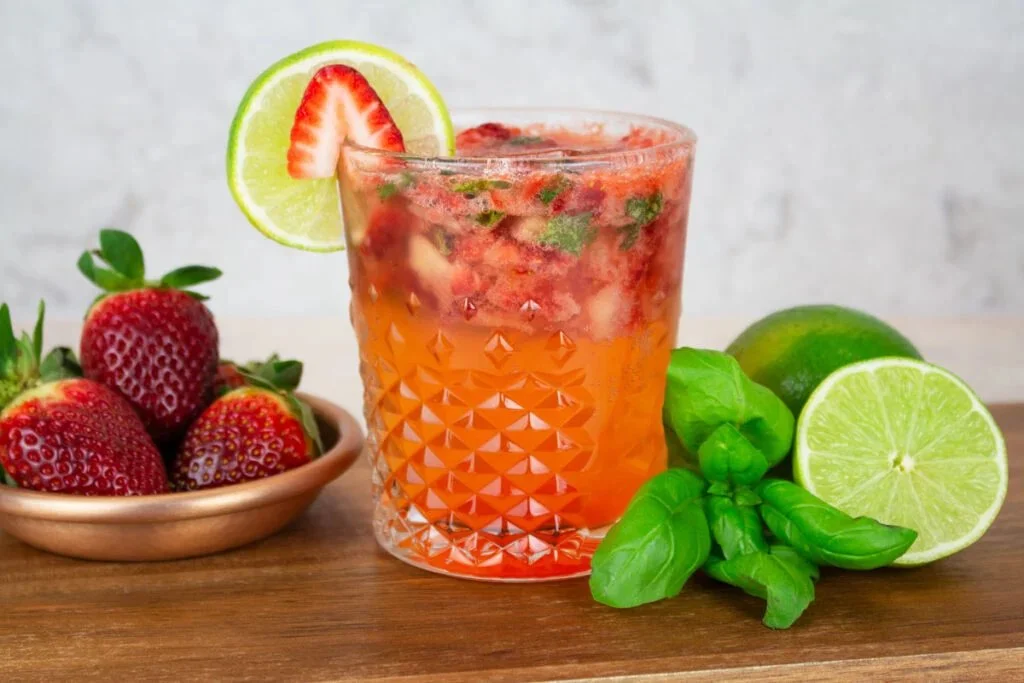 Strawberry basil sparkling mocktail served in a glass with fresh ingredients