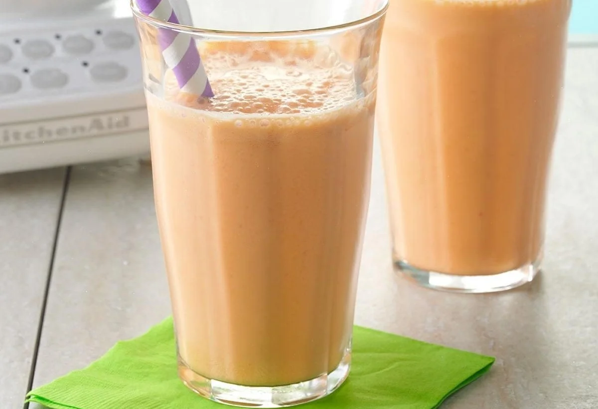 Delicious strawberry-carrot smoothies garnished with fresh strawberries and carrots.