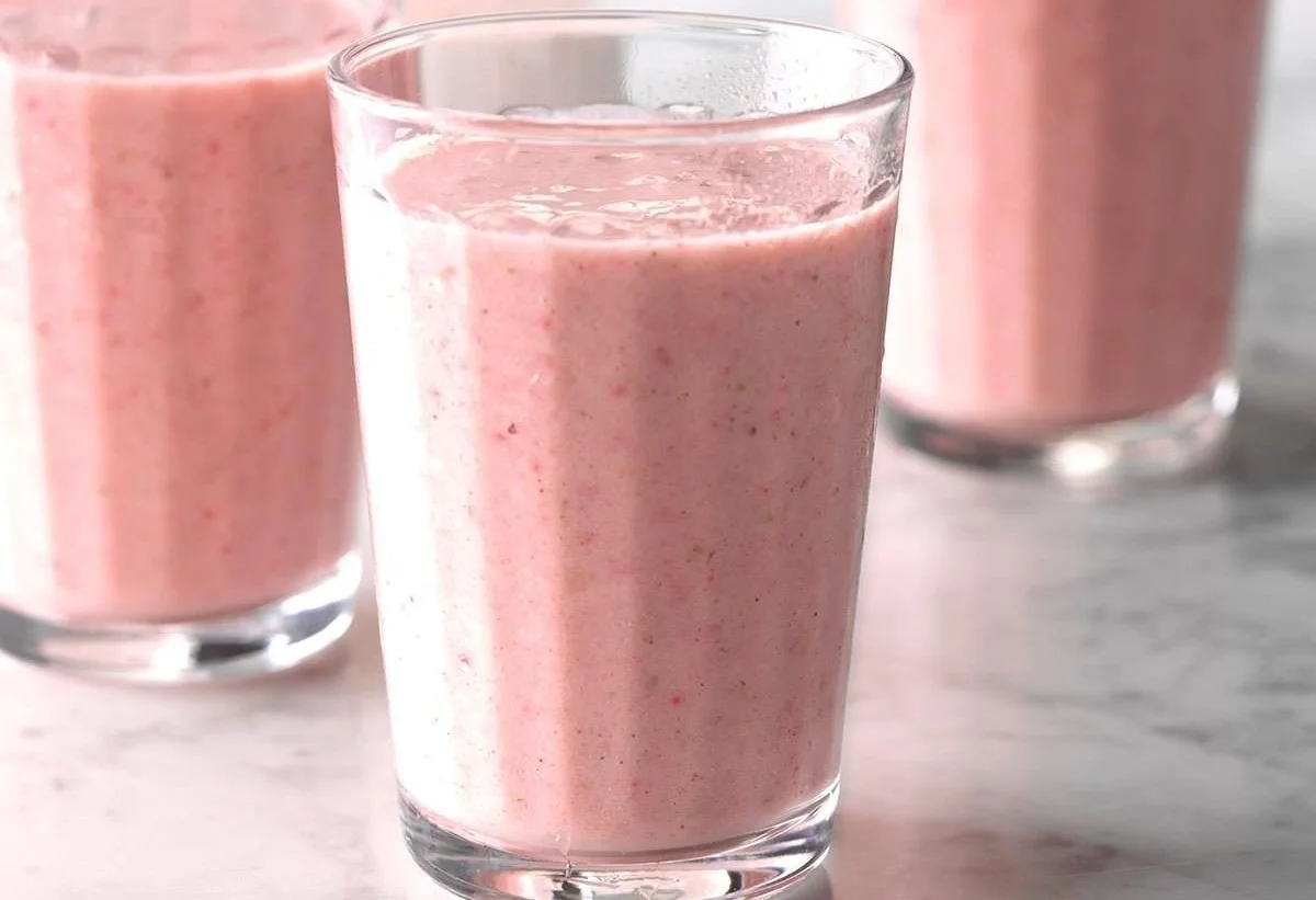 Delicious strawberry lime smoothies in a glass with fresh strawberries and limes