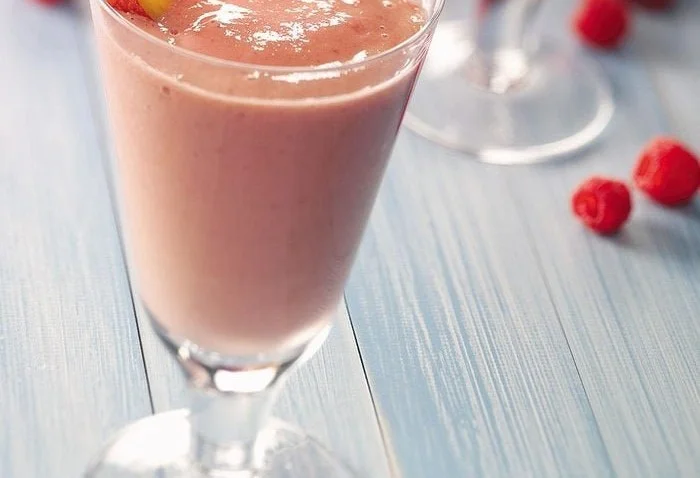 A refreshing strawberry watermelon slush in a vibrant cup, perfect for hot days.
