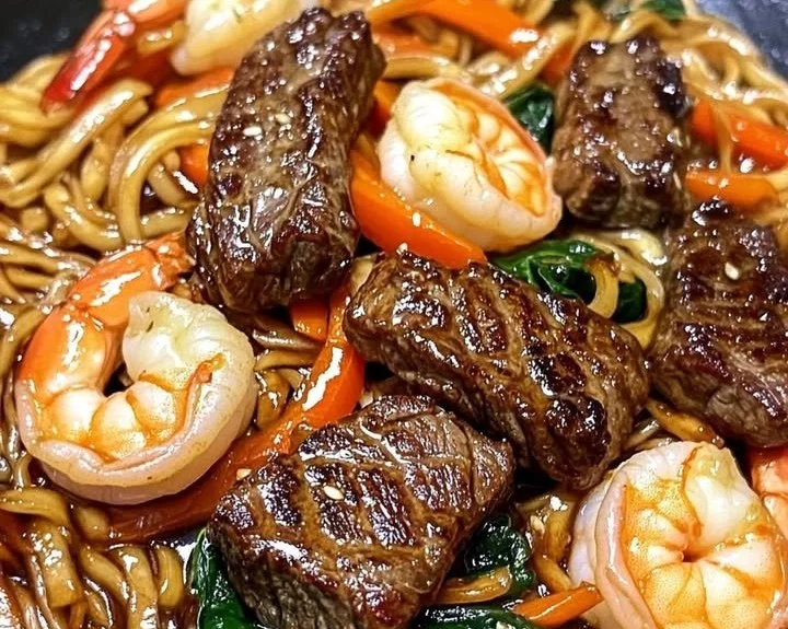 Delicious Surf & Turf Steak & Shrimp Lo Mein dish presented attractively.