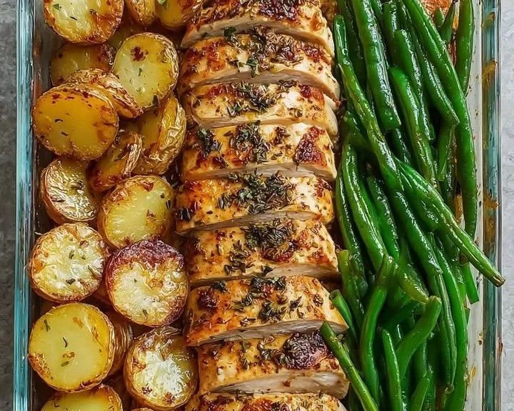 One-pan herb chicken with roasted potatoes and green beans on a plate