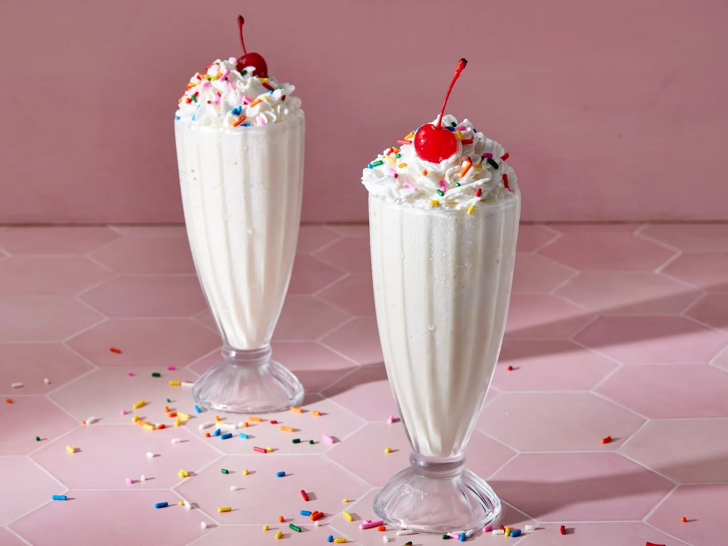 Delicious vanilla milkshake topped with whipped cream and a cherry