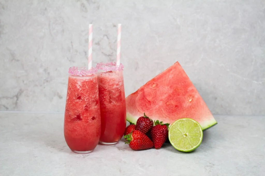 A refreshing watermelon strawberry mocktail served in a glass with mint leaves.