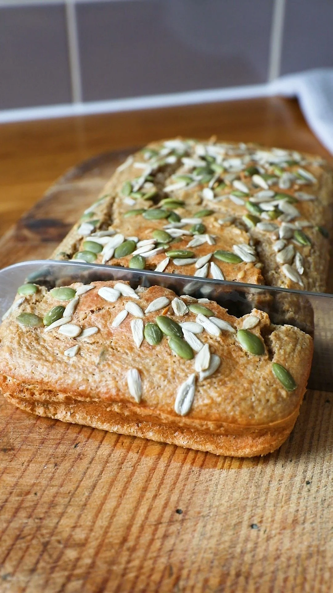 Gluten-free seed bread with mixed seeds on a wooden table