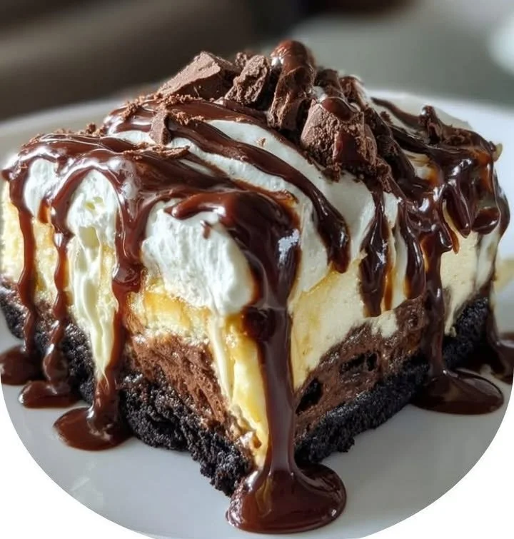 Delicious hot fudge sundae brownie cheesecake topped with chocolate and fudge sauce