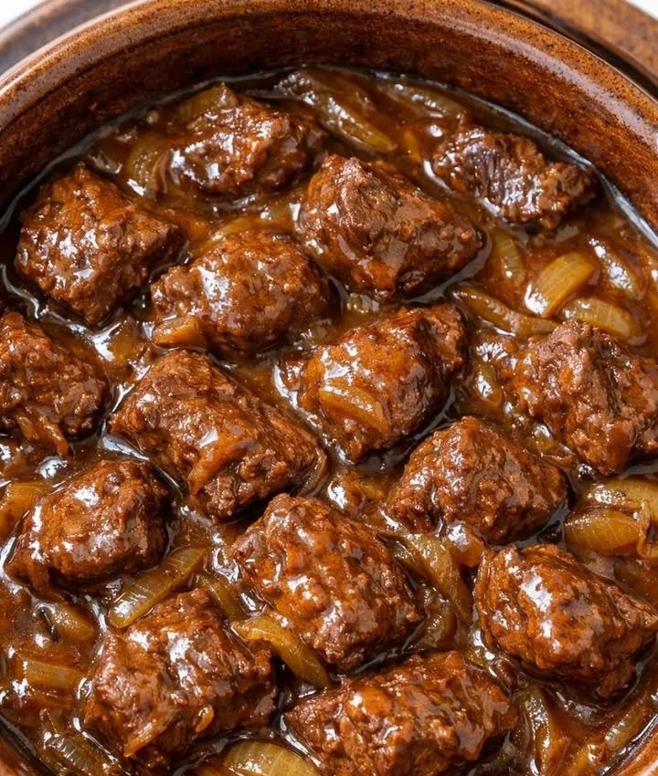 A plate of perfectly slow cooked meat served with vegetables and garnishes.