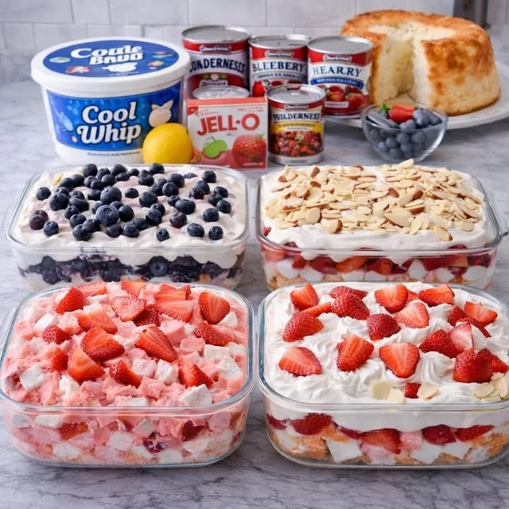 Slices of fluffy Angel Food Cake on a plate with strawberries and whipped cream