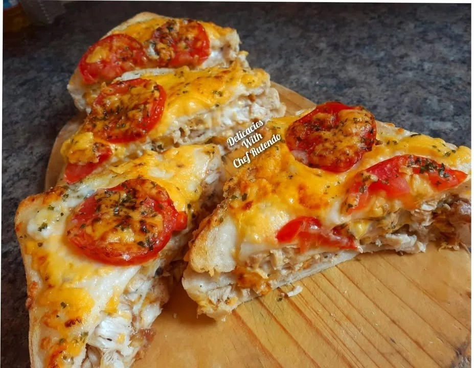 Delicious chicken mayo sandwich on a plate with fresh ingredients.