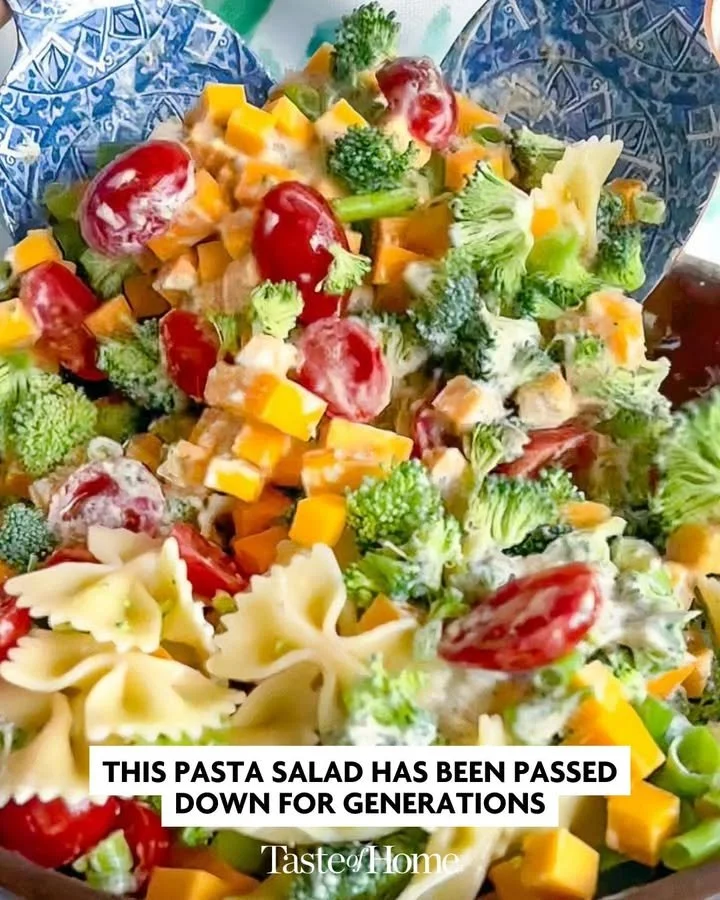 Creamy pasta salad with colorful vegetables and dressing in a bowl