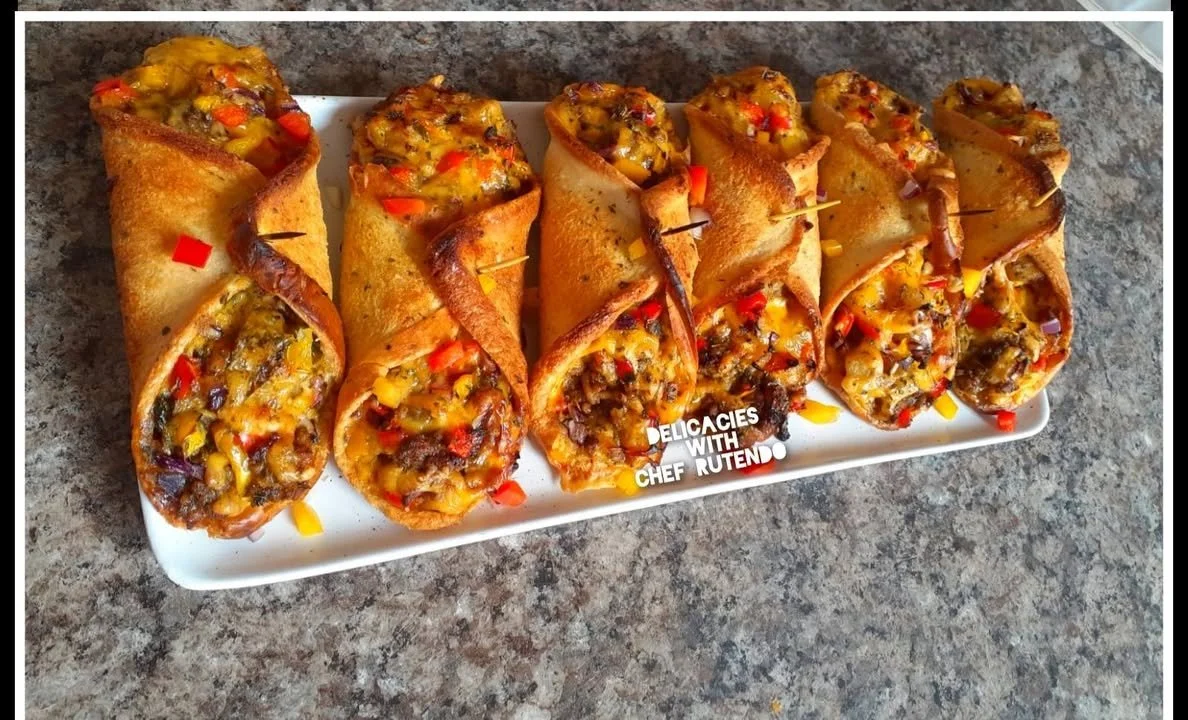 Freshly baked mince meat and cheese bread rolls on a wooden board