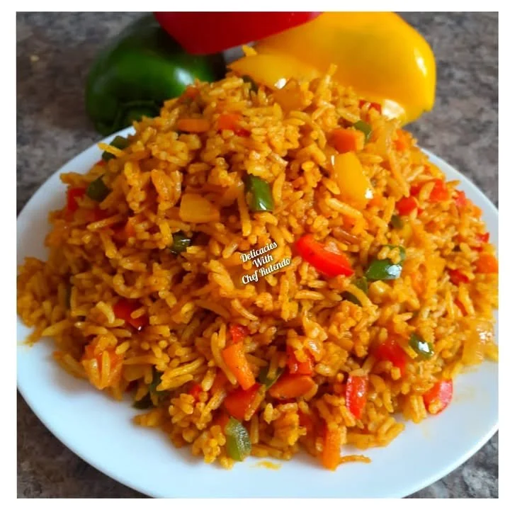 Nandos Spicy Rice served in a bowl with herbs and spices arrayed around it.