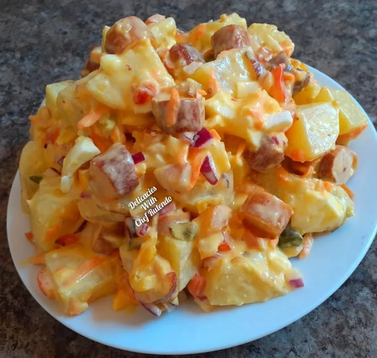 Delicious potato salad served in a bowl, garnished with herbs.