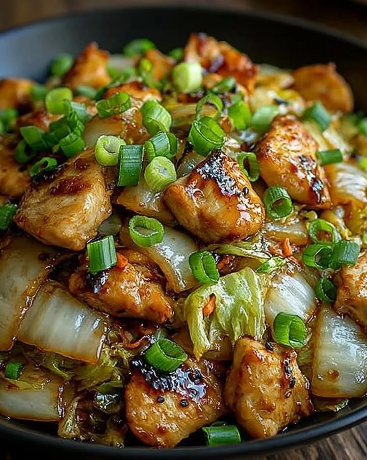 Sizzling garlic chicken with tender cabbage in a skillet dish